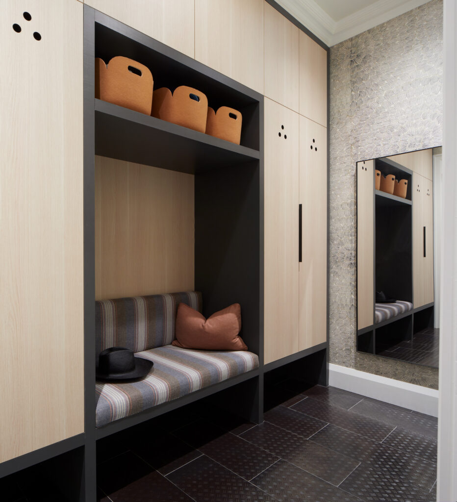 Custom mudroom cabinetry with built-in bench seating and overhead storage by Gillian Gillies Interiors